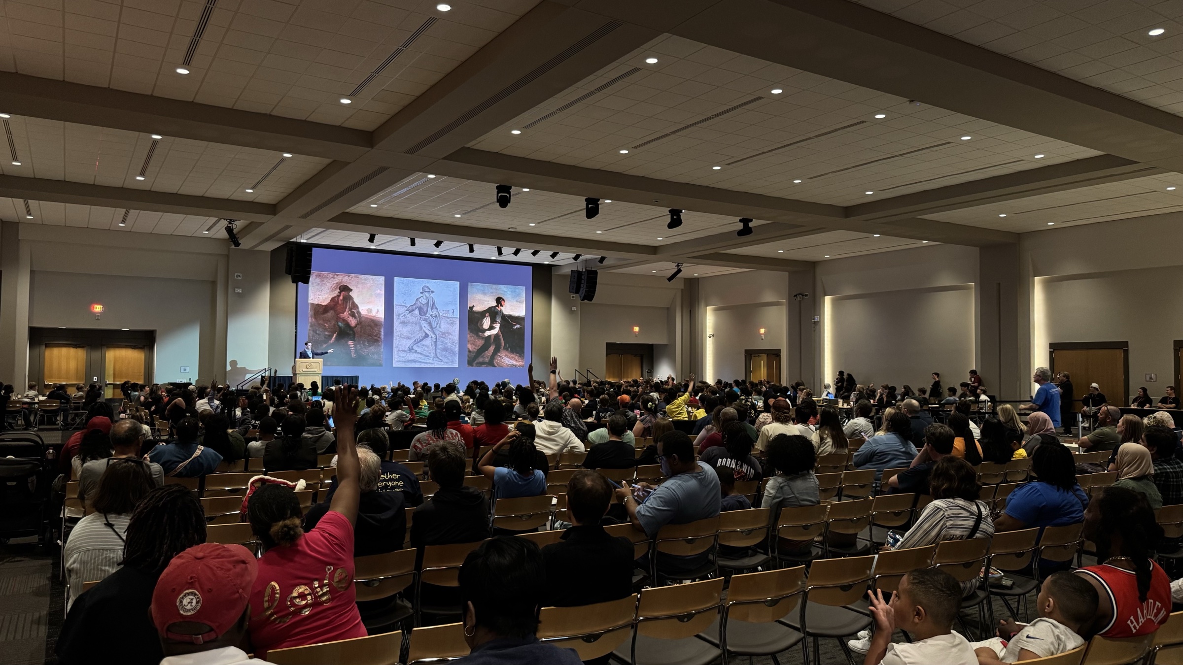 Joshua Jones presenting to a large audience