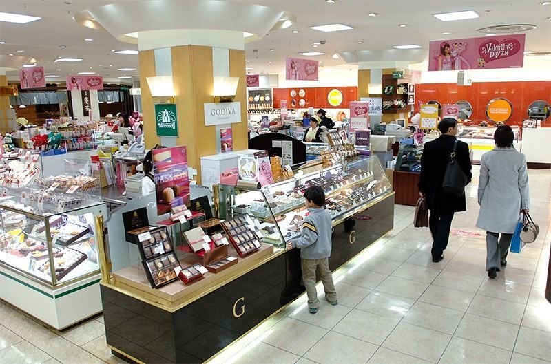 Rows of sweets counters and display cases in a Japanese department-store food hall
