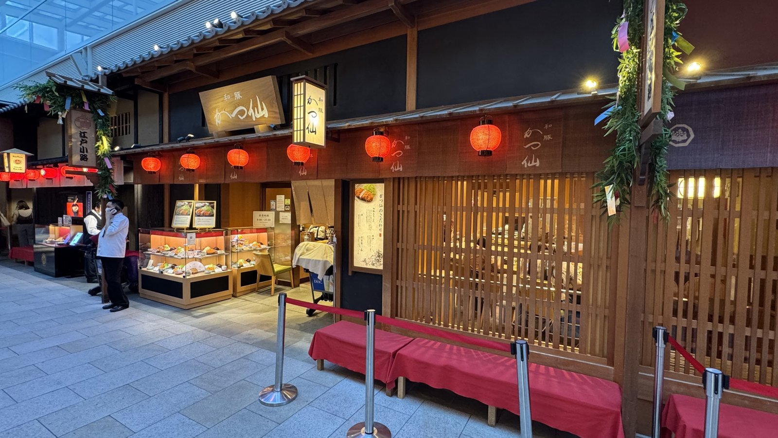 Katsusen’s wood-fronted restaurant at Haneda Airport, with red lanterns and its Japanese name on the sign