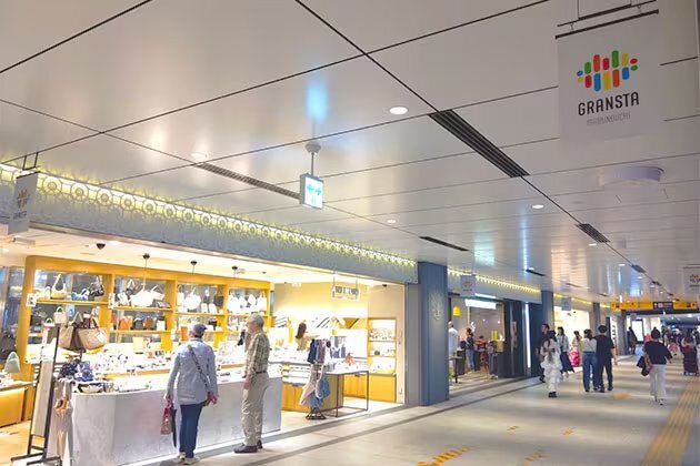 Shoppers passing food counters in the Gransta shopping area at Tokyo Station
