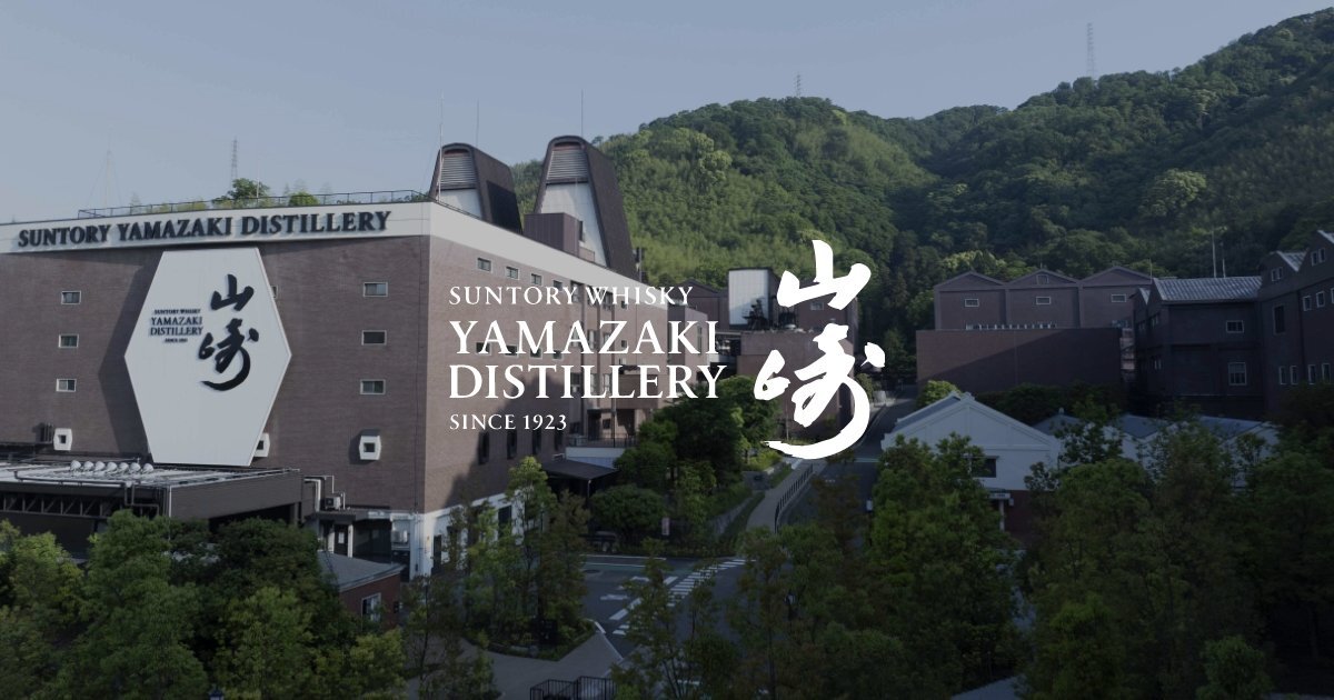 The Suntory Yamazaki Distillery building beneath wooded hills